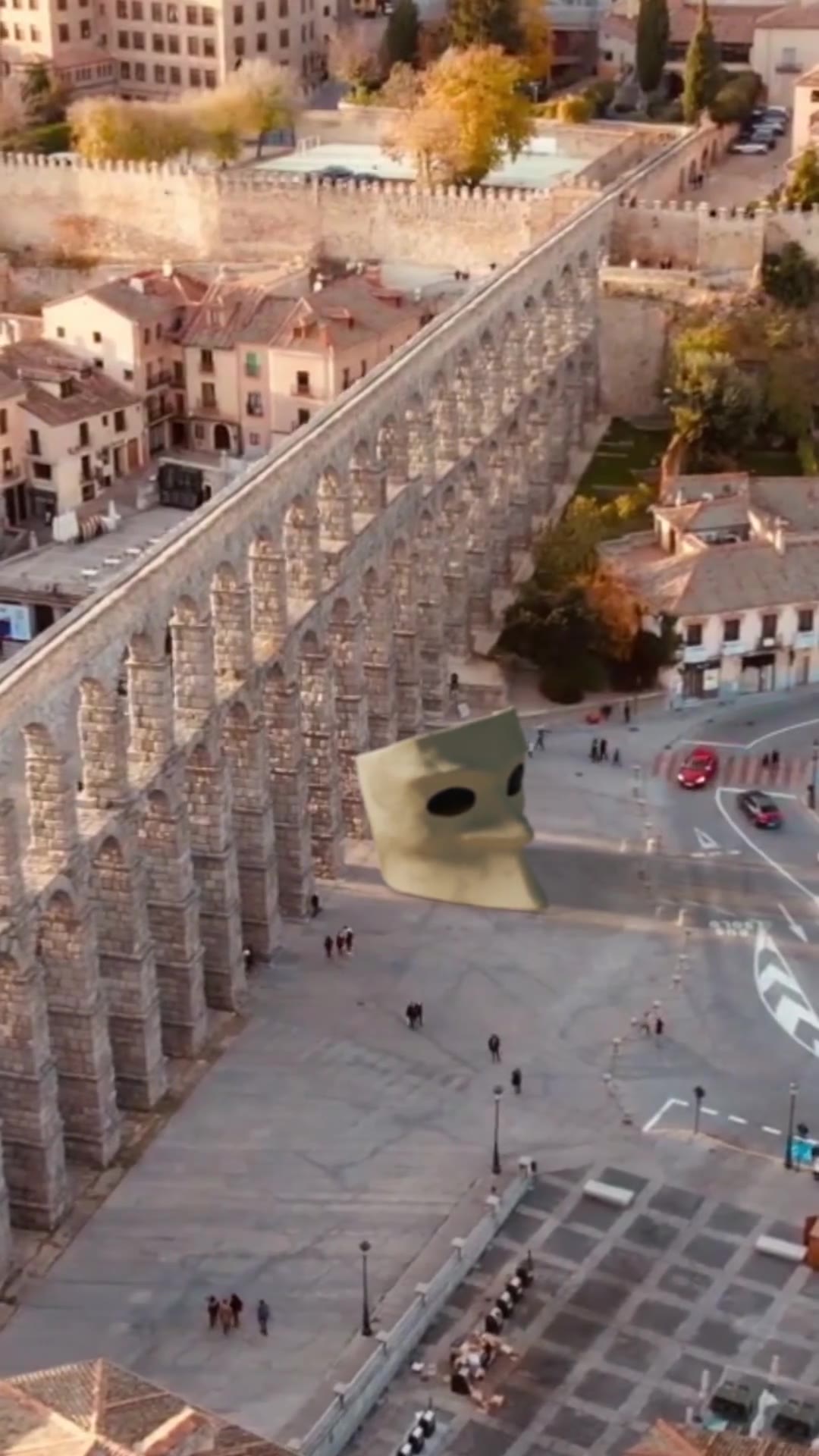 Escape City Box mask integrated into an urban aqueduct plaza